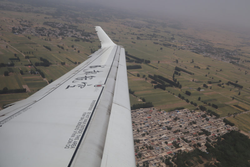 an airplane wing and a city