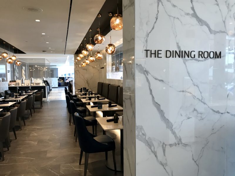 a restaurant with marble walls and chairs