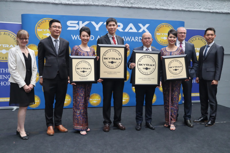 a group of people holding awards