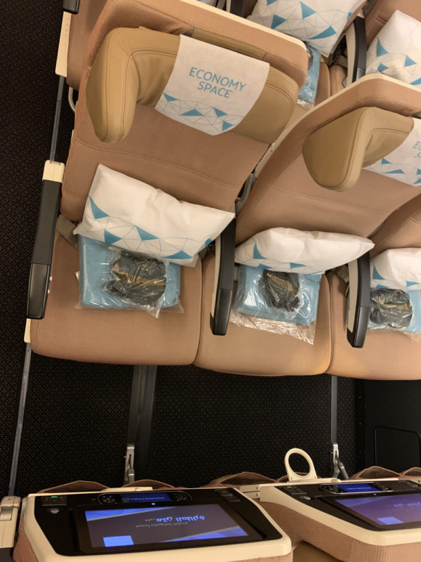 a row of seats with bags on them