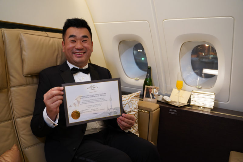 a man in a suit holding a certificate in his hand