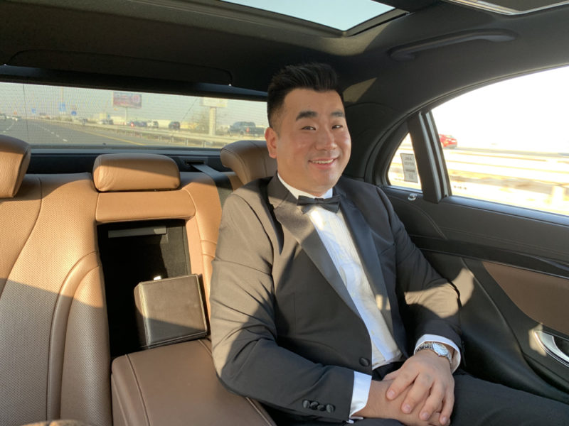 a man in a suit sitting in a car