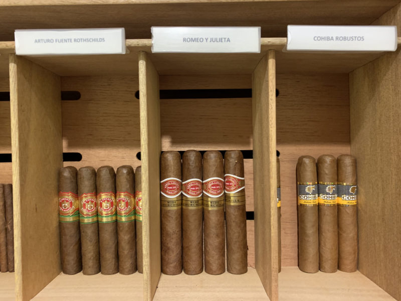 a row of cigars on a shelf