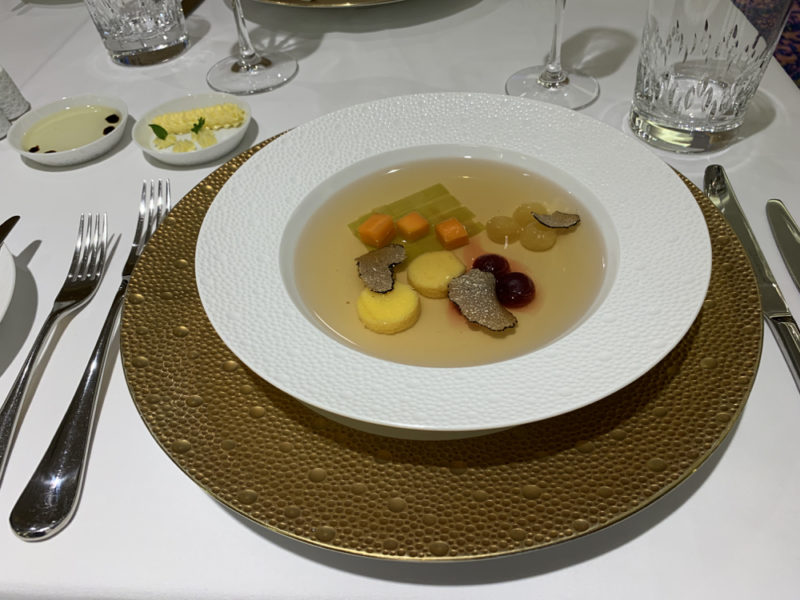a plate of soup with vegetables and mushrooms