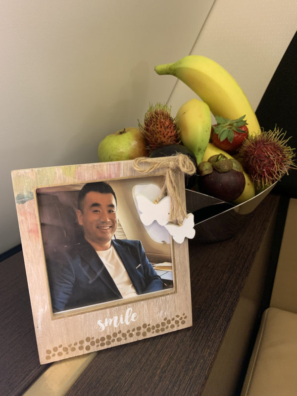 a picture frame and a bowl of fruit