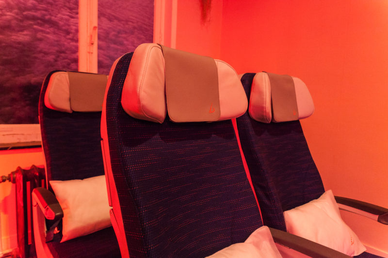 a row of seats with pillows