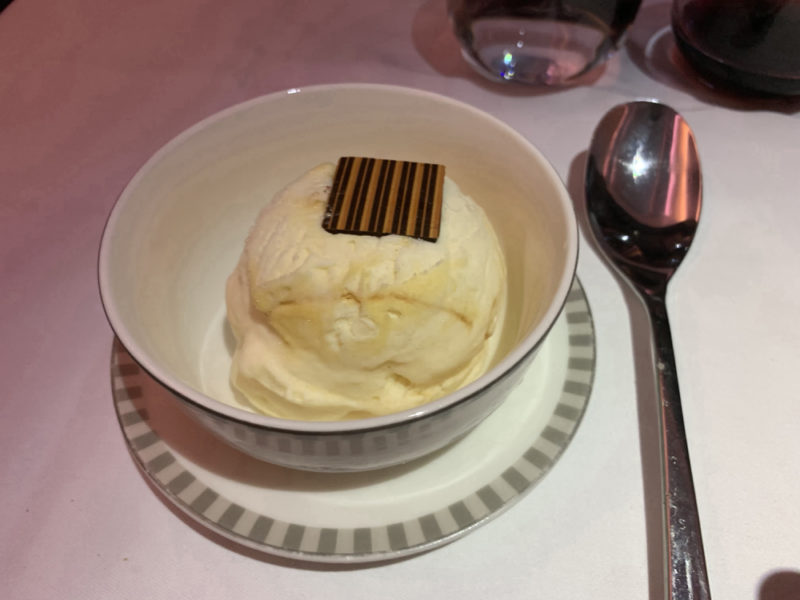 a bowl of ice cream with a chocolate bar on top