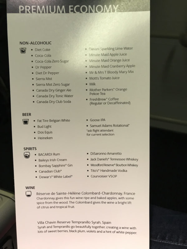 a menu of drinks on a plane