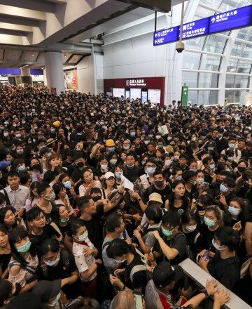 a large crowd of people in a station