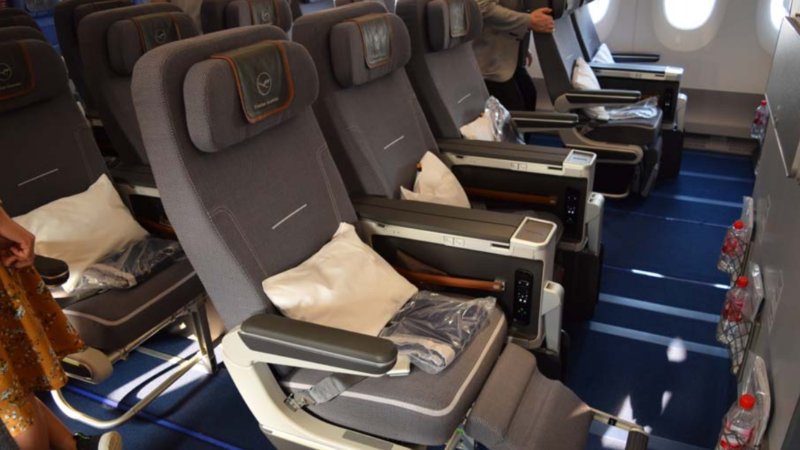 a row of grey seats in an airplane