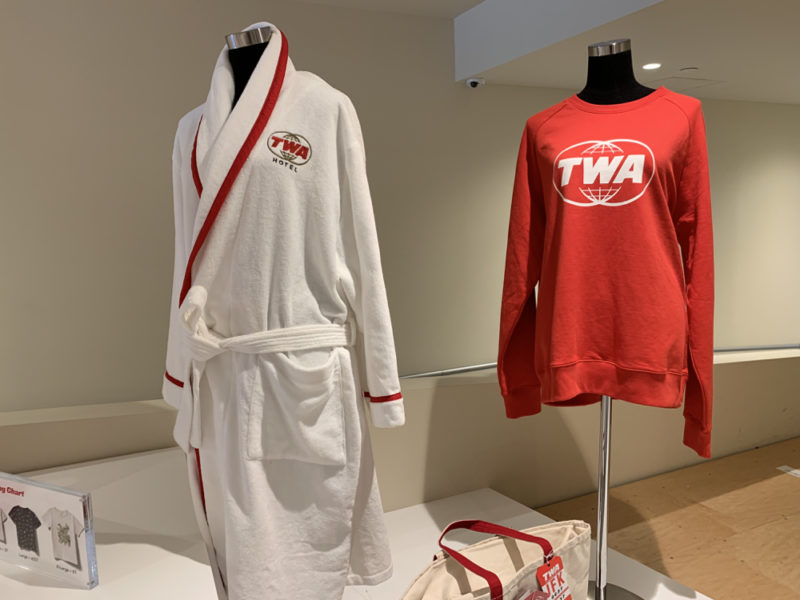 a white and red robe and a red shirt on a mannequin