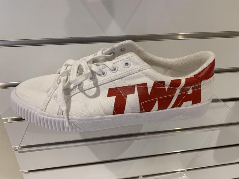 a white shoe with red text on it