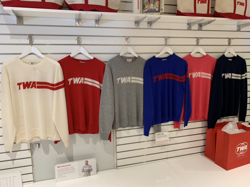 a group of sweaters on swingers in a store