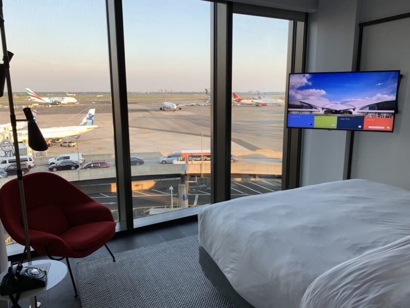 a room with a bed and a television and a runway