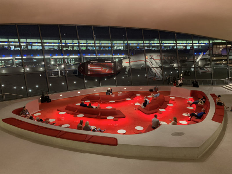 a large circular area with red tables and chairs