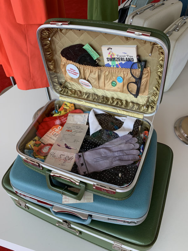 a suitcase with clothes and gloves inside