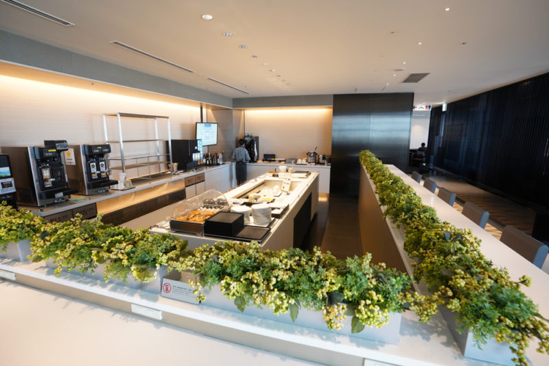 a kitchen with plants on the side