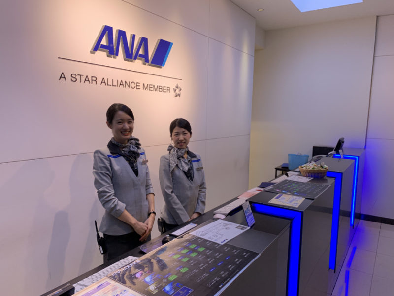 two women standing in front of a desk