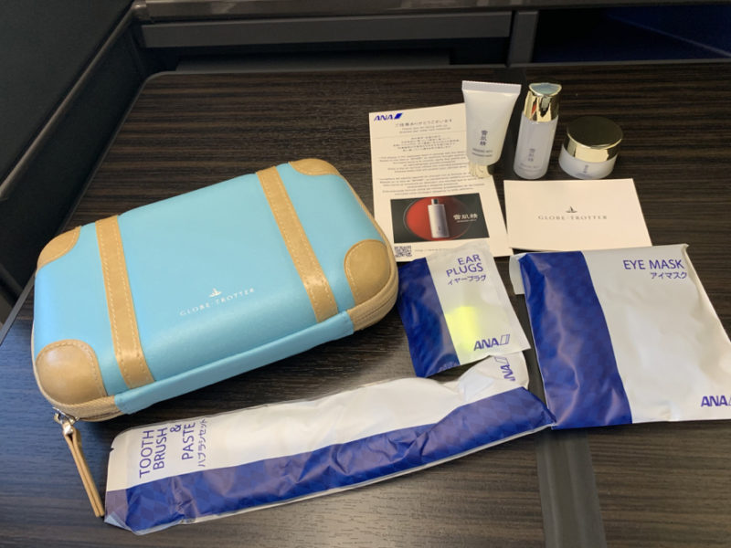 a blue and white bag with a few other items on a table