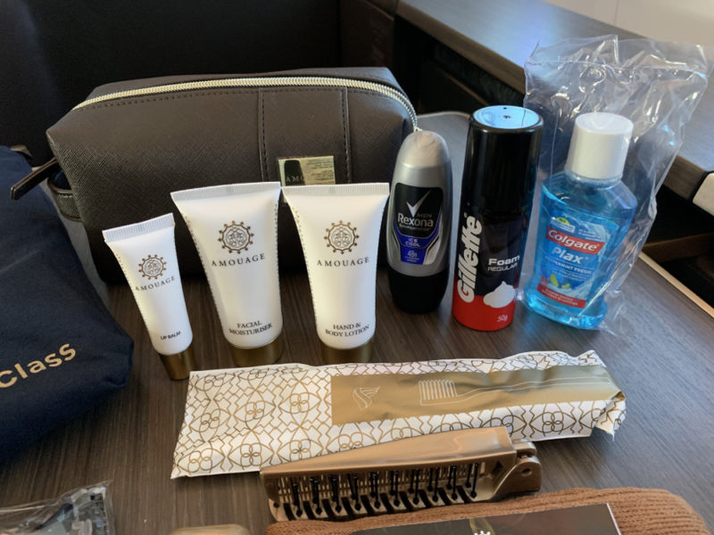 a group of toiletries and a bag on a table