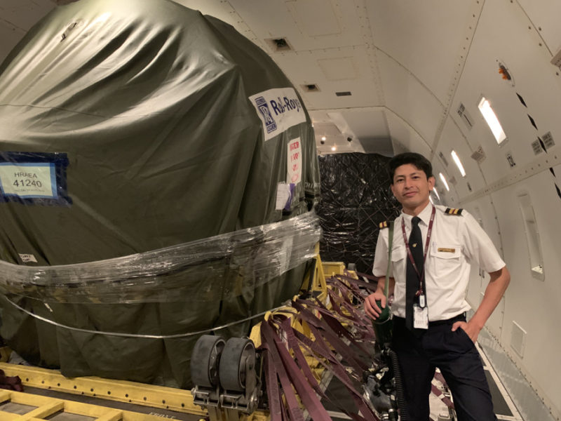 a man standing next to a large object