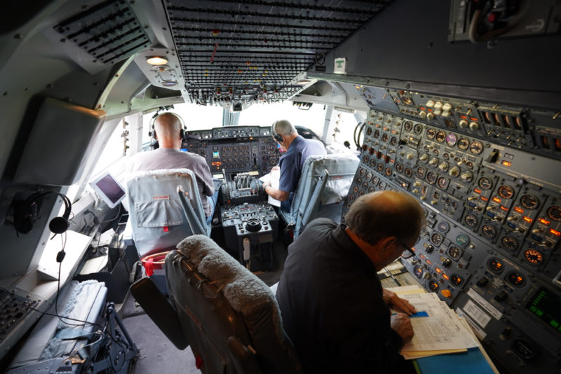 men in the cockpit of a plane