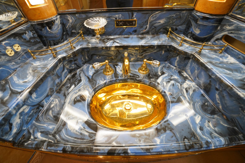 a marbled sink with gold fixtures