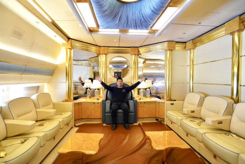 a man sitting in a chair in a room with white furniture