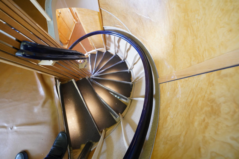 a spiral staircase with a person walking down it