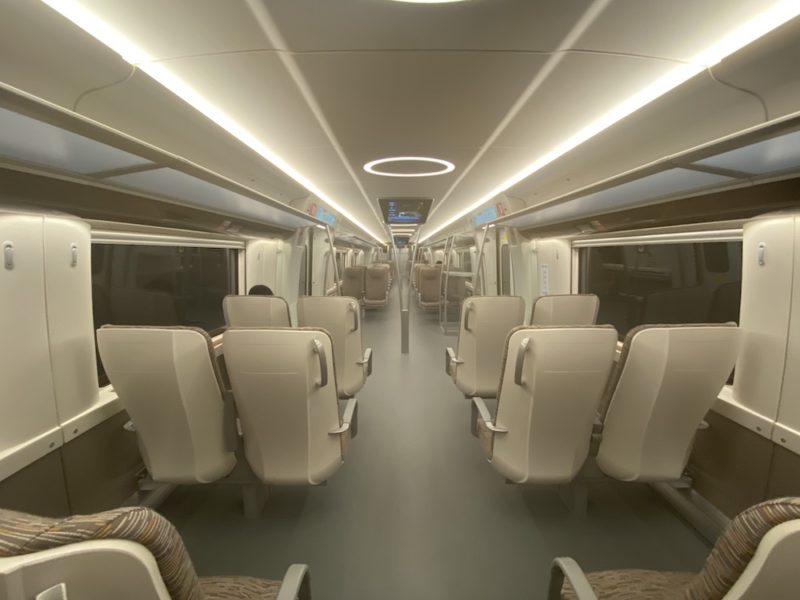 a train with seats and a person sitting in it