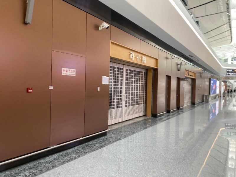 a hallway with brown doors and a white ceiling