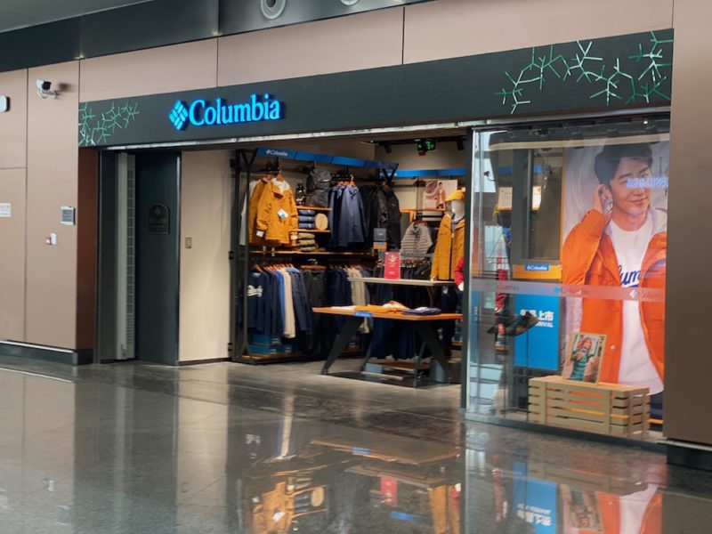 a store front with a sign and a man on the phone