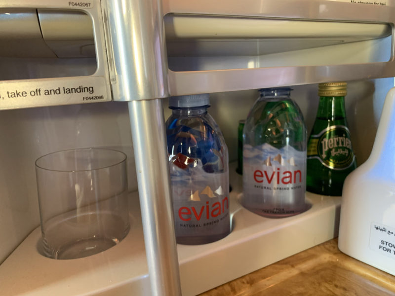 bottles and a glass on a shelf