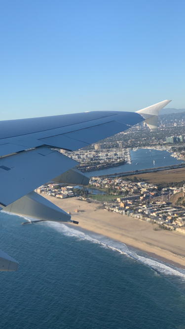 an airplane wing and water and city