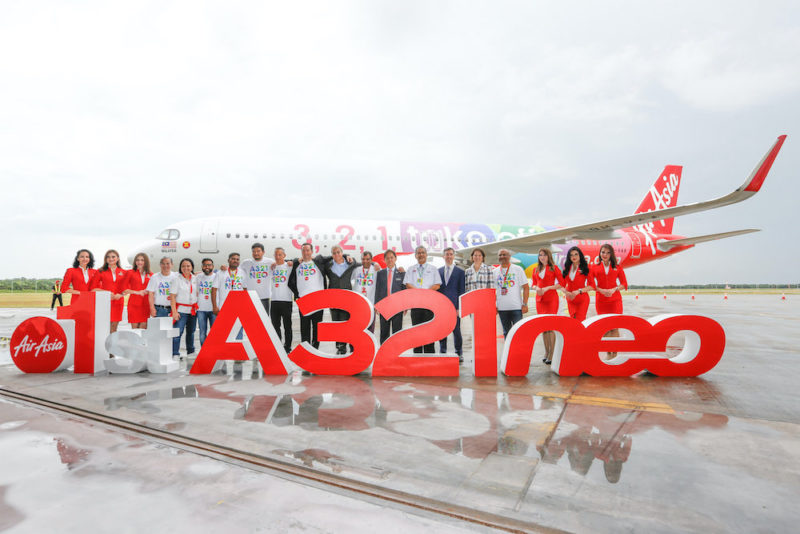 a group of people standing in front of a plane