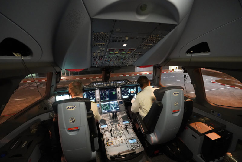 men sitting in the cockpit of an airplane