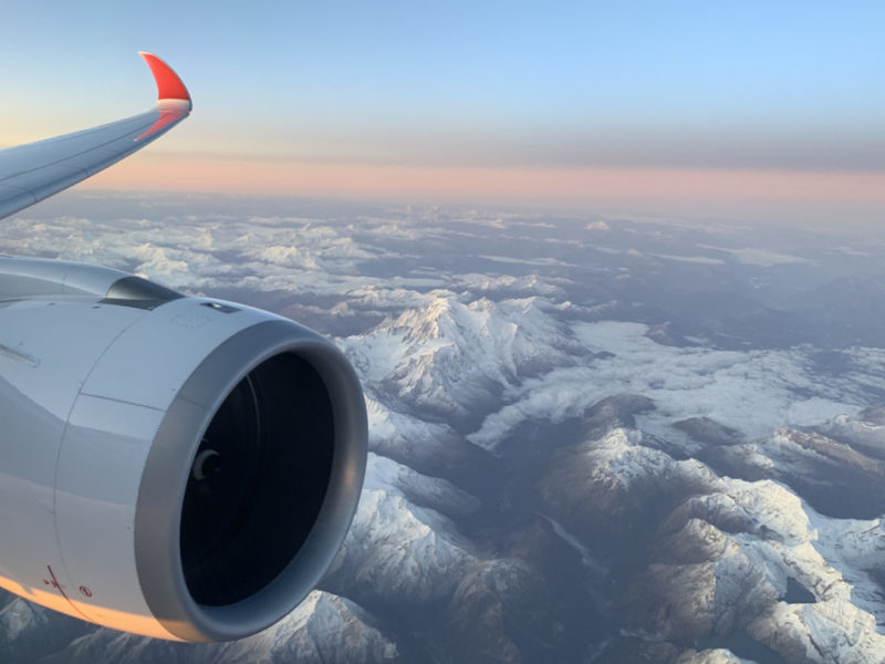 an airplane wing and a view of mountains