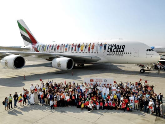 a group of people standing in front of an airplane