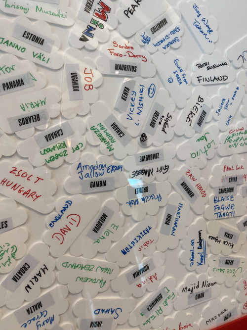 a group of white tags with writing on them