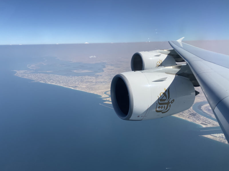 an airplane wing with a large engine above the water