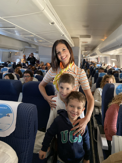 a woman and two children on an airplane