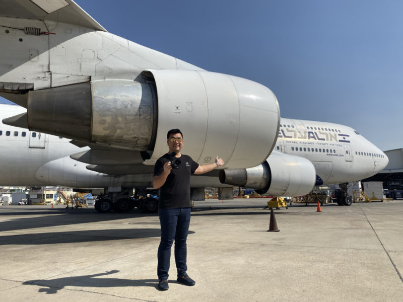 a man standing in front of an airplane