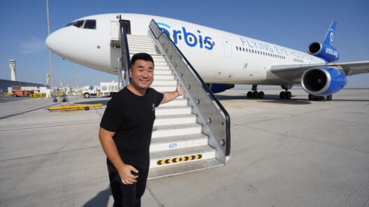 a man standing next to a plane