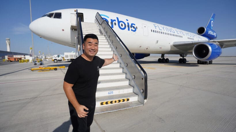 a man standing next to a plane