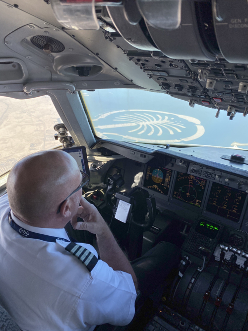 a man in a pilot's uniform in an airplane cockpit