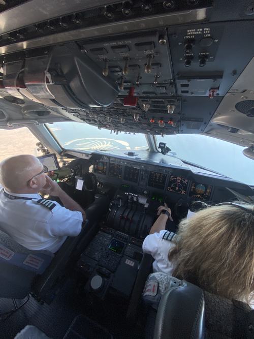 a man and woman in the cockpit of an airplane
