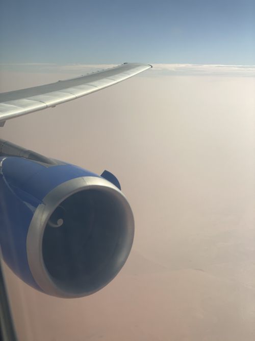 an airplane wing and a blue and silver engine