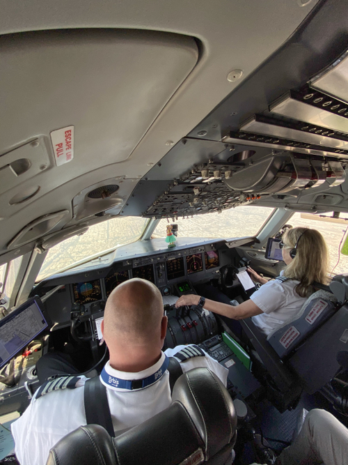 a man and woman in the cockpit of an airplane