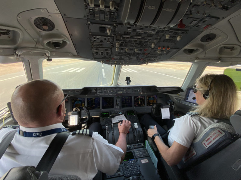 a man and woman in a cockpit of an airplane