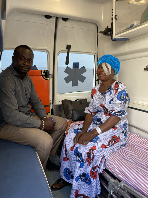 a man and woman sitting in a ambulance